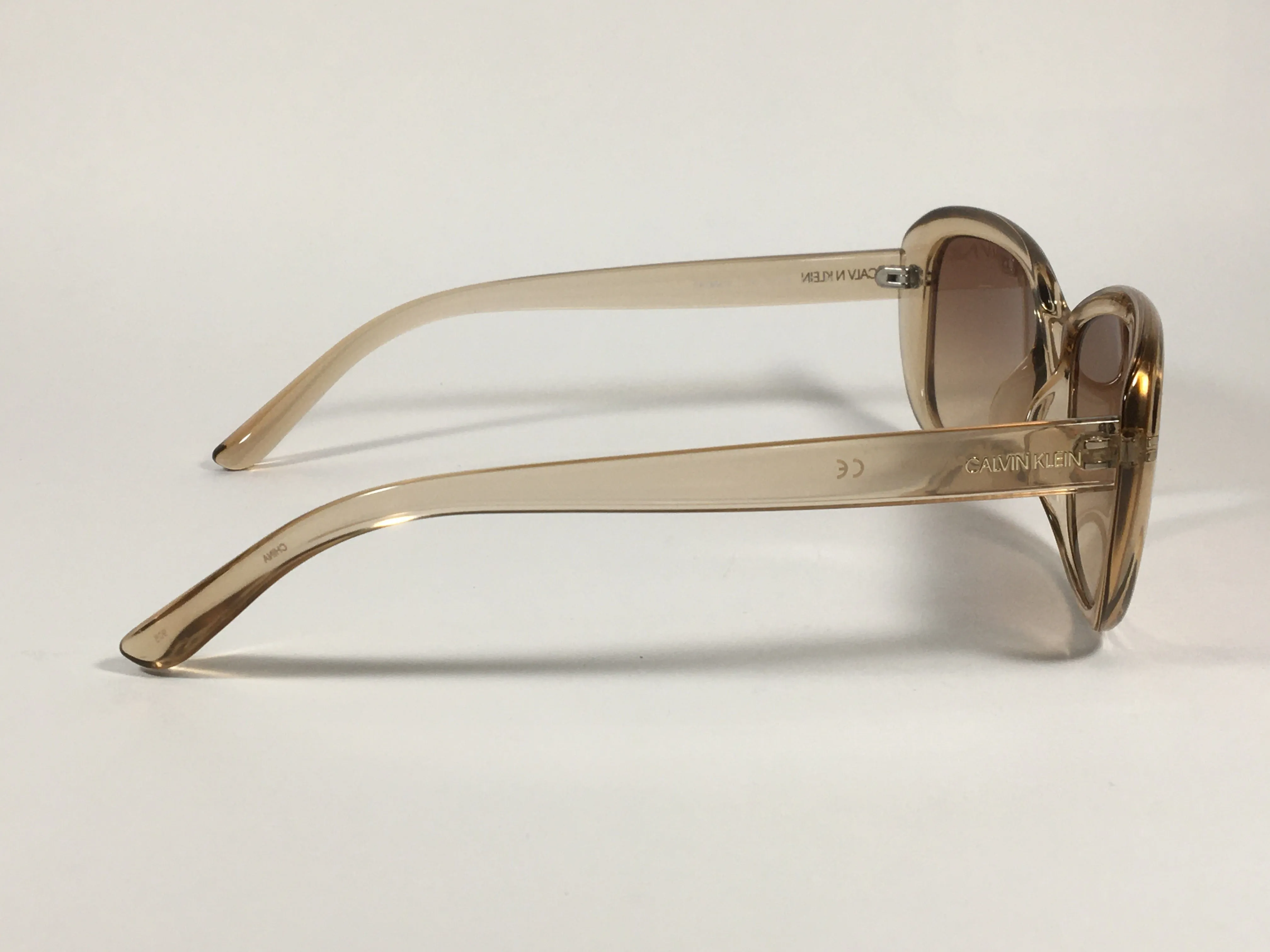 Calvin Klein Oval Sunglasses CK19541S 270 Light Brown Crystal Frame Brown Gradient Lens