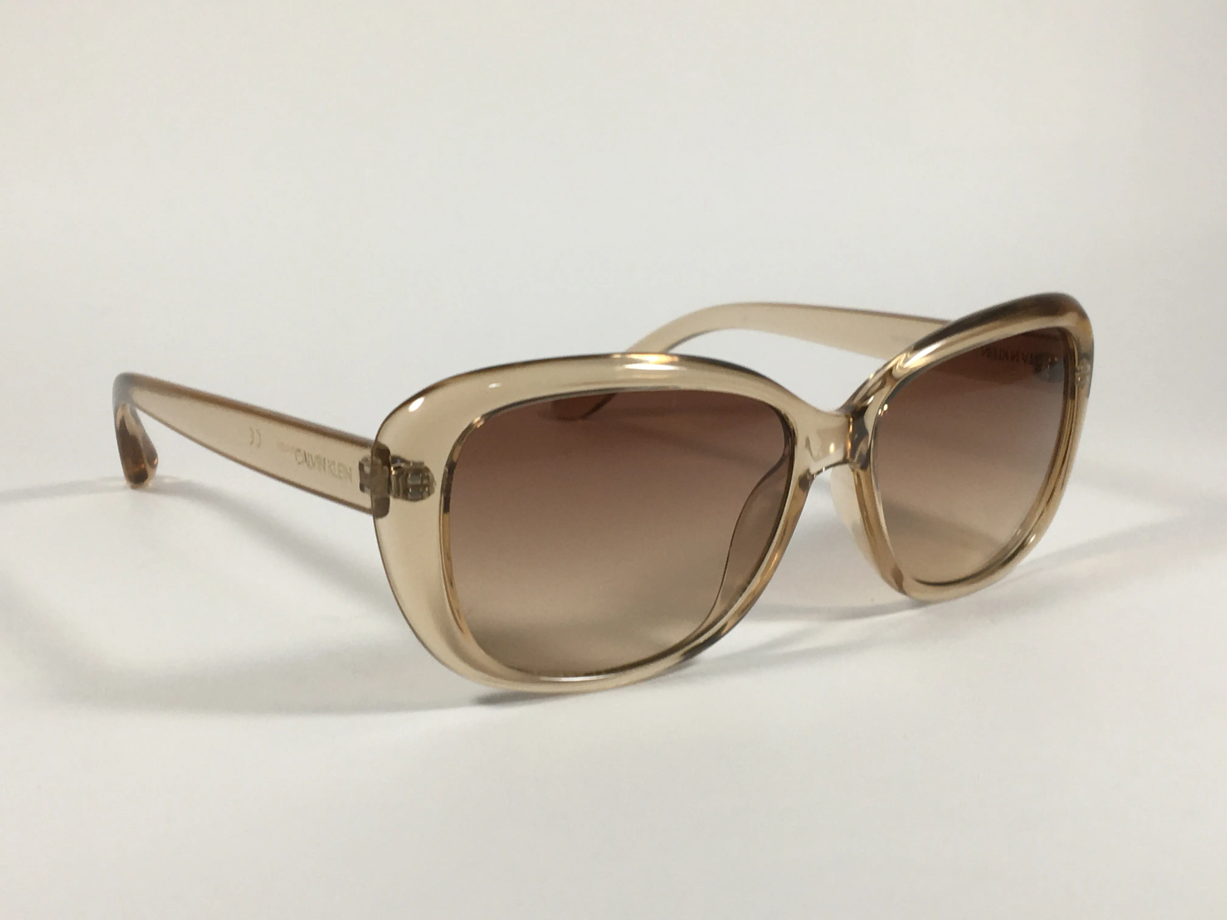 Calvin Klein Oval Sunglasses CK19541S 270 Light Brown Crystal Frame Brown Gradient Lens