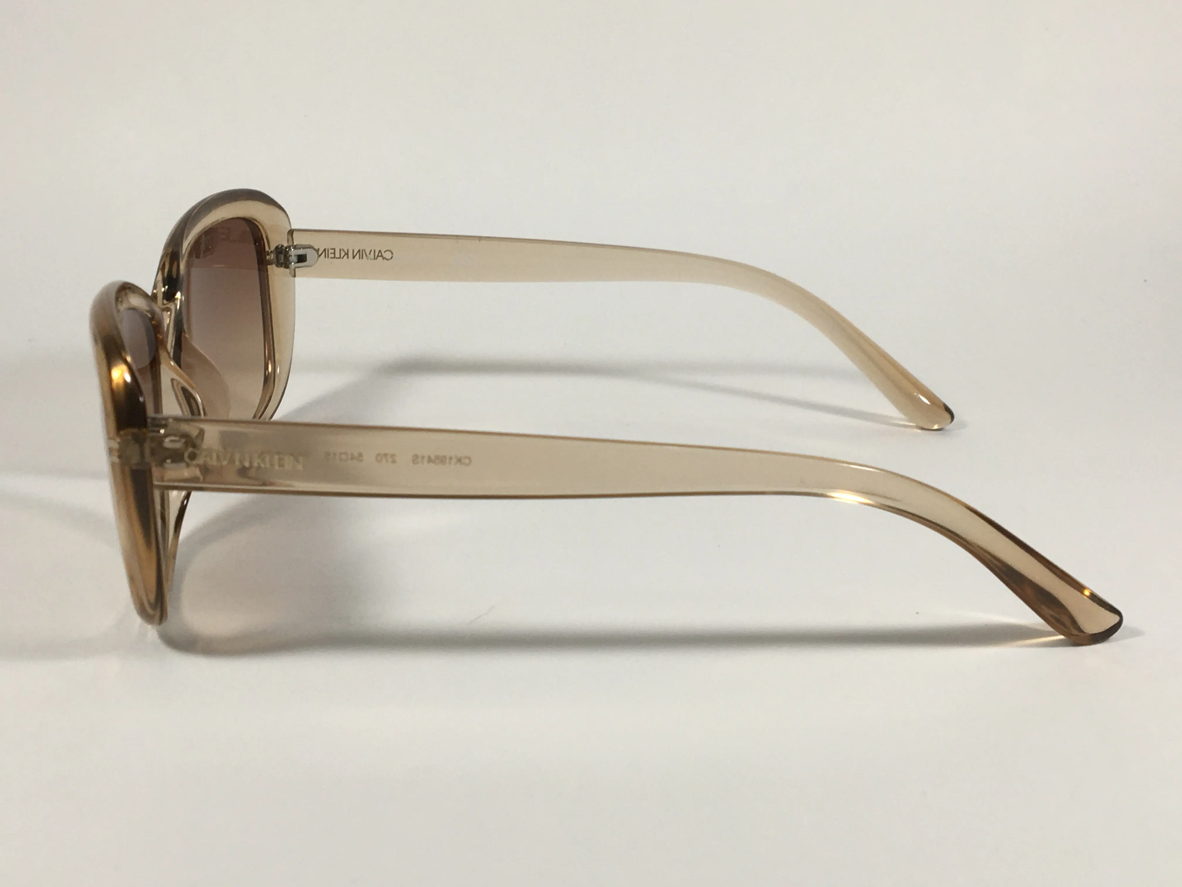 Calvin Klein Oval Sunglasses CK19541S 270 Light Brown Crystal Frame Brown Gradient Lens
