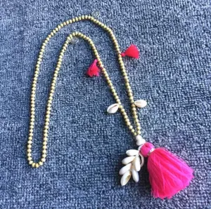 Wooden Beads Necklace with Cowry Shells and Cotton Tassels | Erika Williner Designs